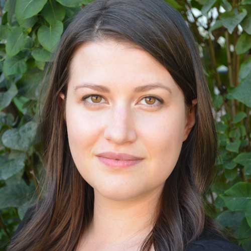 headshot of dr jola sikorski in front of leaves