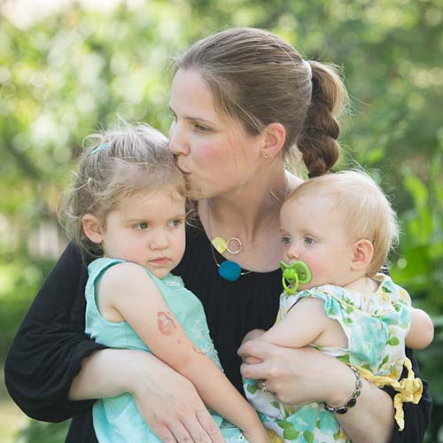 Dr Kealy Mann holding her two children